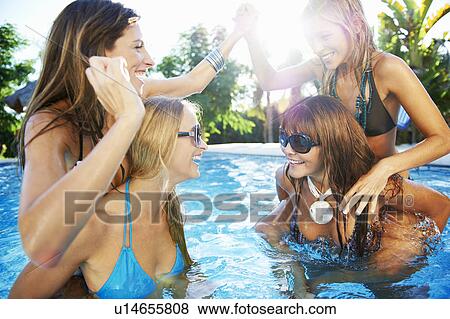 Girls playing in swimming pool View Large Photo Image Stock Photo - Girls playing in swimming pool. Fotosearch