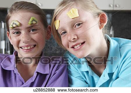 Girls playing with fruit View Large Photo Image Stock Photo - Girls playing with fruit. Fotosearch
