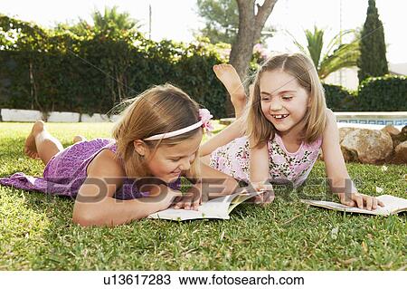 Stock Image - Girls reading books. Fotosearch
