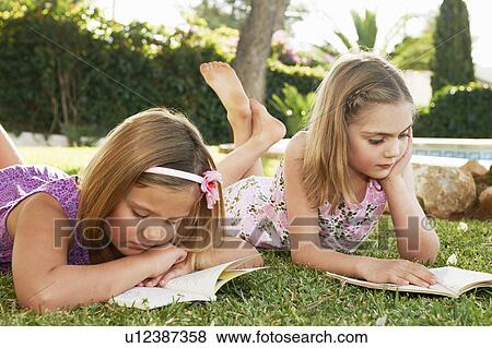 Stock Photo - Girls reading books. Fotosearch