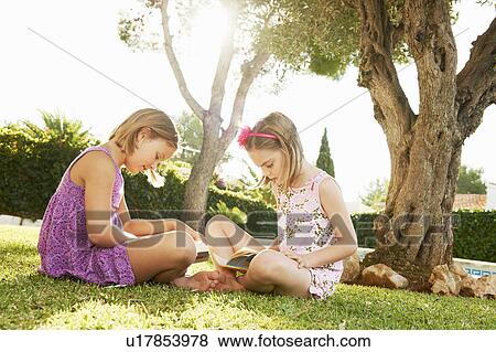 Girls reading books View Large Photo Image Stock Photo - Girls reading books. Fotosearch