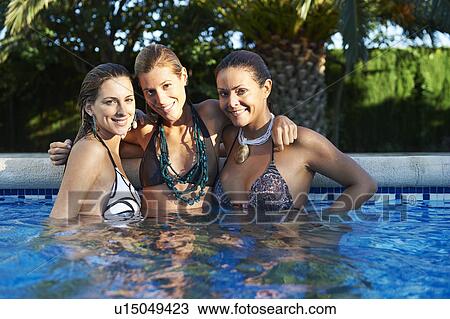Girls relaxing in swimming pool View Large Photo Image Stock Image - Girls relaxing in swimming pool. Fotosearch