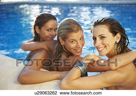 Girls relaxing in swimming pool View Large Photo Image Stock Image - Girls relaxing in swimming pool. Fotosearch