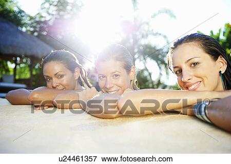 Girls relaxing in swimming pool View Large Photo Image Stock Photo - Girls relaxing in swimming pool. Fotosearch