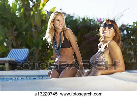 Stock Photography - Girls relaxing in swimming pool. Fotosearch