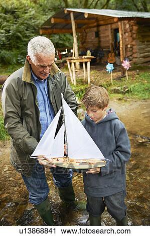 Grandfather and boy with sailing boat View Large Photo Image Stock Image - Grandfather and boy with sailing boat. Fotosearch
