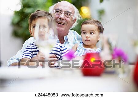 Grandfather and children having lunch View Large Photo Image Stock Image - Grandfather and children having lunch. Fotosearch