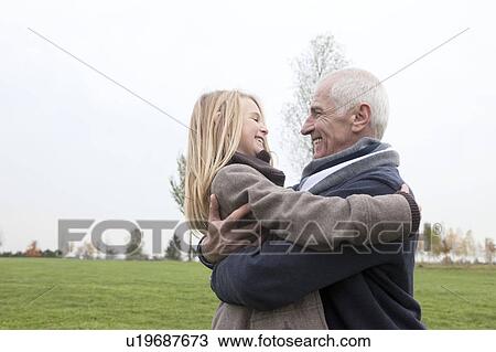 Grandfather and granddaughter outdoors View Large Photo Image Stock Image - Grandfather and granddaughter outdoors. Fotosearch