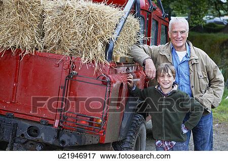 Stock Photo - Grandfather and Grandson by 4x4 on farm. Fotosearch