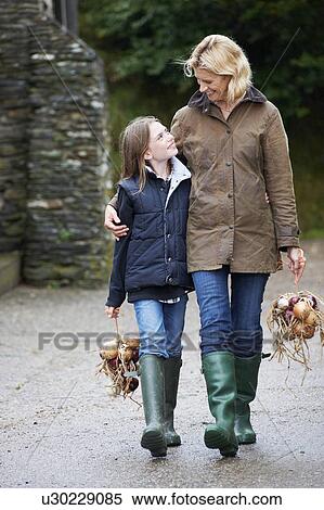Grandmother and girl carrying vegetables View Large Photo Image Stock Photography - Grandmother and girl carrying vegetables. Fotosearch