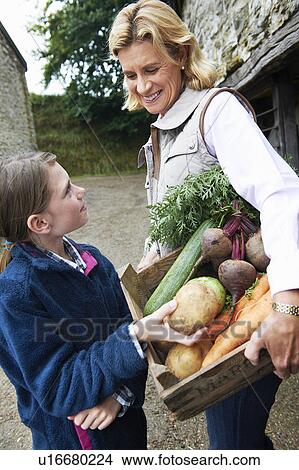Grandmother and girl with vegetables View Large Photo Image Picture - Grandmother and girl with vegetables. Fotosearch