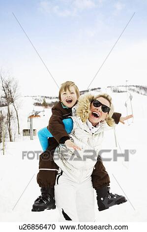 Stock Image - Grandmother with grandson on back. Fotosearch