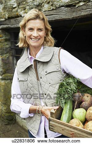 Stock Photograph - Grandmother with vegetables. Fotosearch