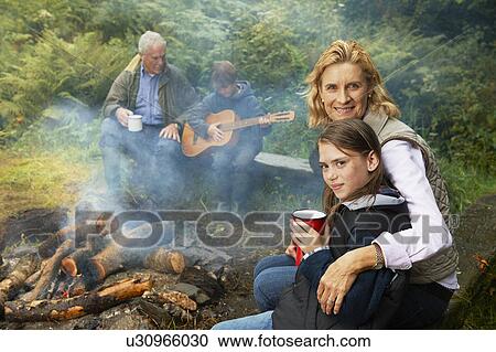 Grandparents and children by camp fire View Large Photo Image Stock Image - Grandparents and children by camp fire. Fotosearch