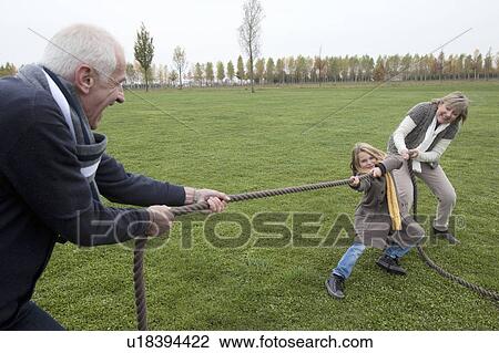 Grandparents and girl playing tug-of-war View Large Photo Image Stock Image - Grandparents and girl playing tug-of-war. Fotosearch