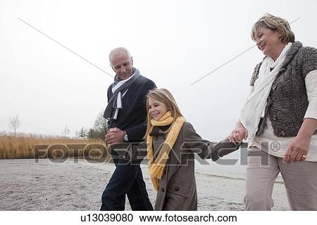 Grandparents and girl walking by lake View Large Photo Image Stock Image - Grandparents and girl walking by lake. Fotosearch