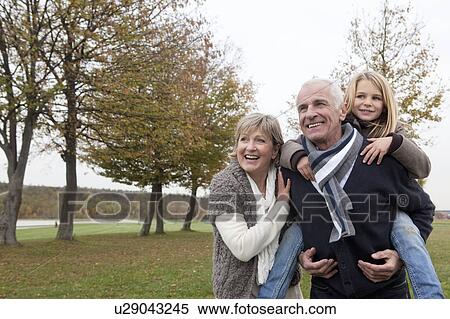 Stock Photography - Grandparents and granddaughter in autumn. Fotosearch