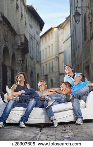 Group look up sitting on couch in street View Large Photo Image Stock Photography - Group look up sitting on couch in street. Fotosearch