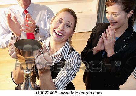 Stock Photograph - Happy colleague receives prize. Fotosearch