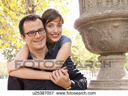 Happy couple embrace in paris park View Large Photo Image Stock Photo - Happy couple embrace in paris park. Fotosearch