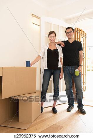 Stock Photography - Happy couple just finished moving in. Fotosearch