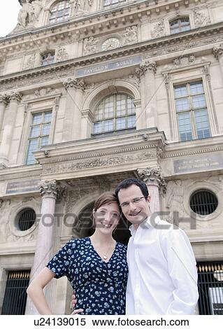 Stock Photography - Happy couple outside the Louvre Paris. Fotosearch
