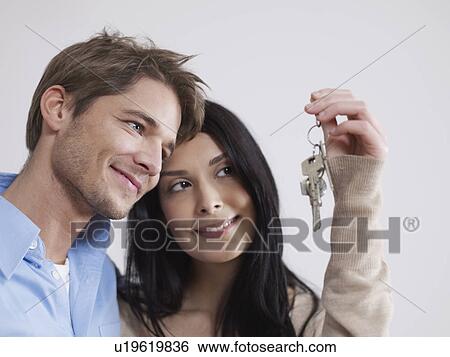 Stock Photograph - Happy couple with new keys to flat. Fotosearch