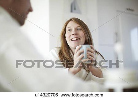 Happy girl drinking coffee in kitchen View Large Photo Image Stock Photograph - Happy girl drinking coffee in kitchen. Fotosearch
