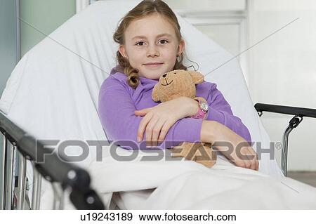 Ill girl with toy in bed, smiling View Large Photo Image Stock Photo - Ill girl with toy in bed, smiling. Fotosearch