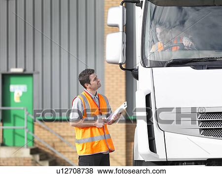 Inspector and truck driver talking View Large Photo Image Stock Photo - Inspector and truck driver talking. Fotosearch