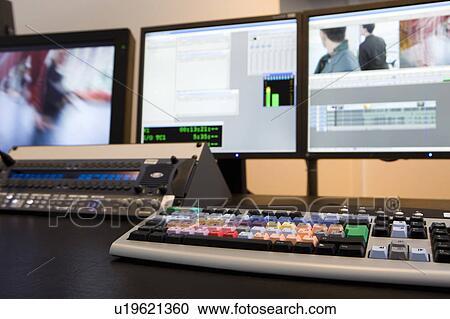 Stock Image - Keyboard in front of screens. Fotosearch