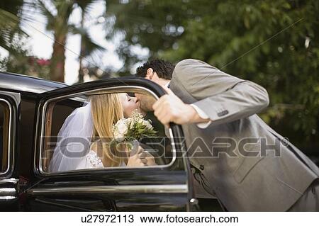 Stock Image - Kissing bridal couple. Fotosearch