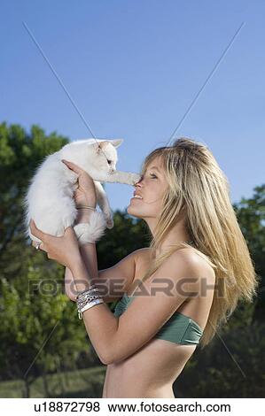 Kitten puts paw to teen girls nose View Large Photo Image Stock Photo - Kitten puts paw to teen girls nose. Fotosearch