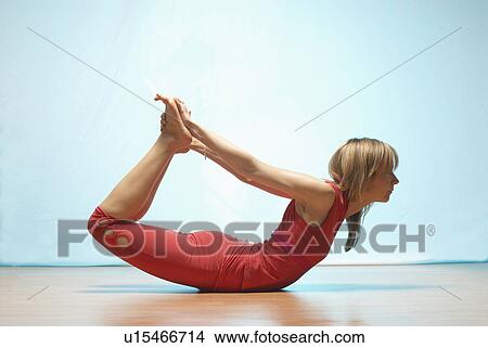 Lady doing yoga in a studio View Large Photo Image Picture - Lady doing yoga in a studio. Fotosearch