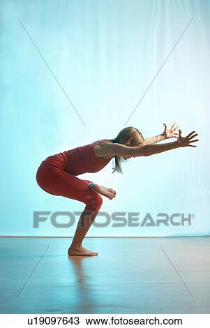 Lady doing yoga in a studio View Large Photo Image Stock Image - Lady doing yoga in a studio. Fotosearch