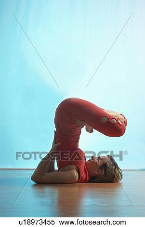 Stock Photography - Lady doing yoga in a studio. Fotosearch