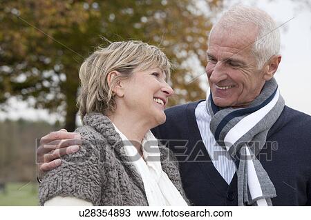 Laughing couple outdoors in autumn View Large Photo Image Stock Image - Laughing couple outdoors in autumn. Fotosearch