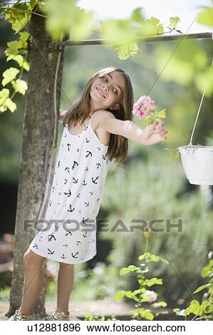 Little girl holding a rose View Large Photo Image Stock Photograph - Little girl holding a rose. Fotosearch