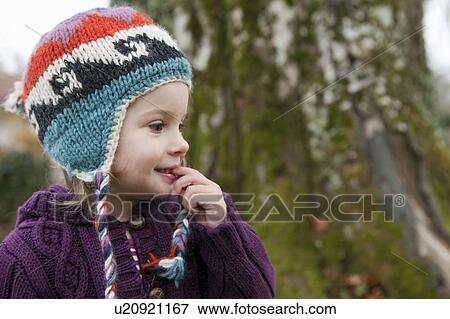 Little girl in knitted sweater and cap View Large Photo Image Stock Photo - Little girl in knitted sweater and cap. Fotosearch