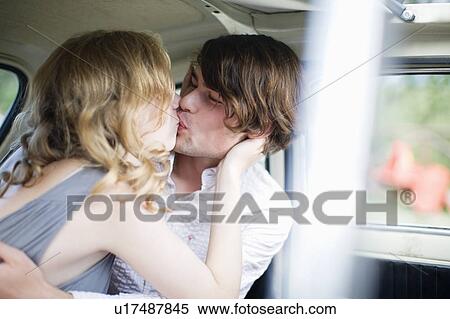 Lovers kissing in the car View Large Photo Image Stock Photography - Lovers kissing in the car. Fotosearch