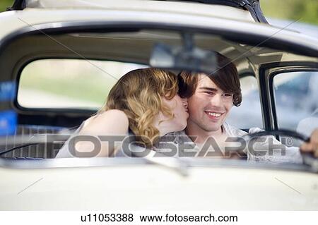 Stock Photo - Loving couple in a car. Fotosearch