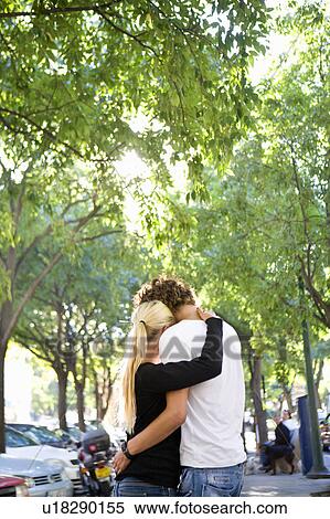 Loving young couple hug in street View Large Photo Image Stock Photography - Loving young couple hug in street. Fotosearch