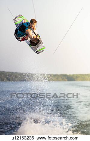 Stock Photograph - Male wakeboarder in air. Fotosearch