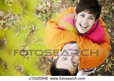 Stock Photo - Man and woman embrace in park workout. Fotosearch