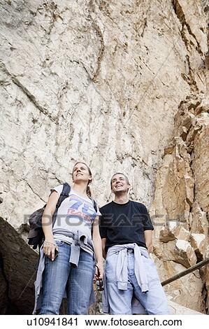 Stock Image - Man and woman on mountain excursion. Fotosearch
