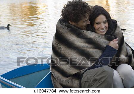 Man and woman snuggling under blanket View Large Photo Image Picture - Man and woman snuggling under blanket. Fotosearch