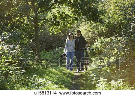 Picture - Man and woman walking in park. Fotosearch