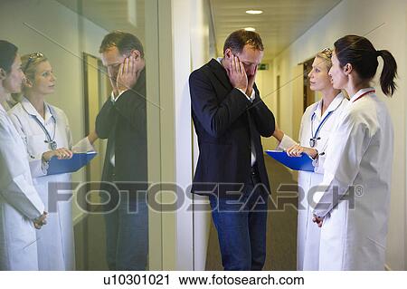 Stock Image - Man at hospital, receiving bad news. Fotosearch