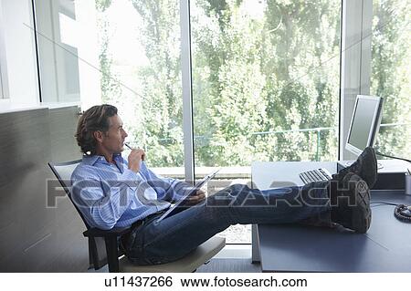 Stock Photograph - Man at the office, relax. Fotosearch