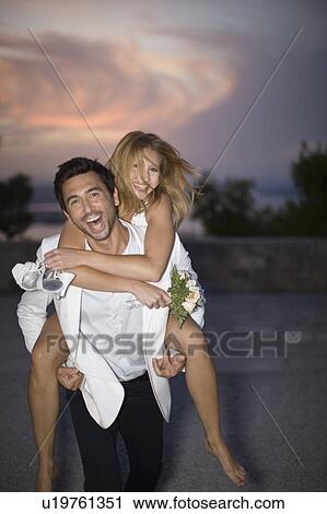 Man carrying his bride View Large Photo Image Stock Image - Man carrying his bride. Fotosearch